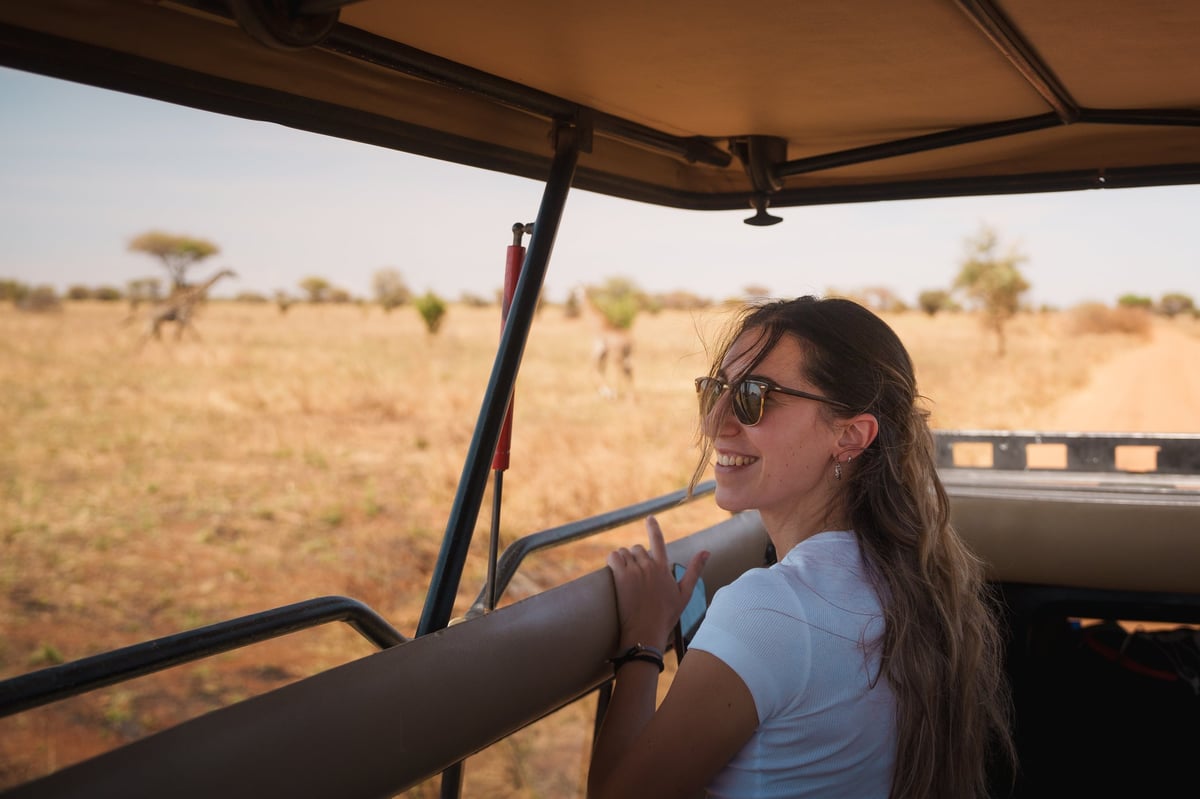 Young woman enjoying a safari trip in Tarangire National Park, Tanzania